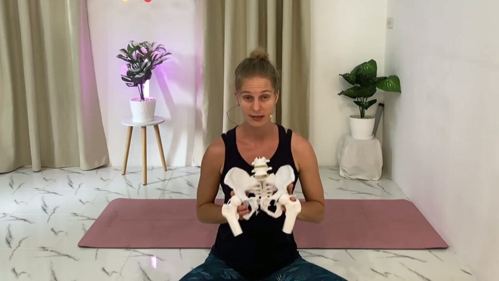 Mareike teaching with a pelvis model in Session 1 of the online course